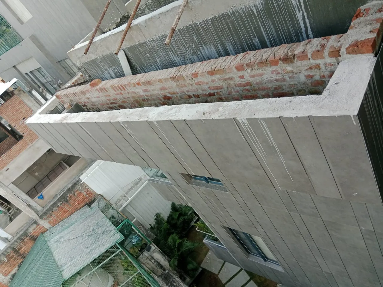 Brick planter box under construction on a high-rise balcony
