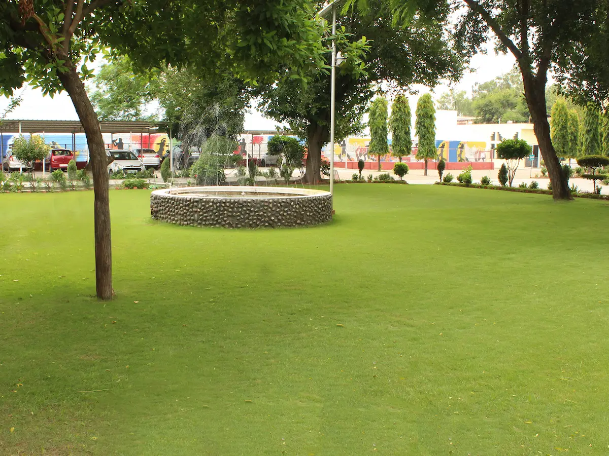 Factory garden lawn with trees and round stone planter