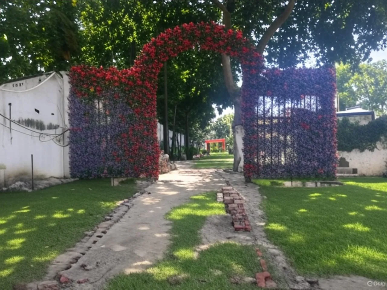 Flower covered entrance arch over a garden path at a Varanasi venue