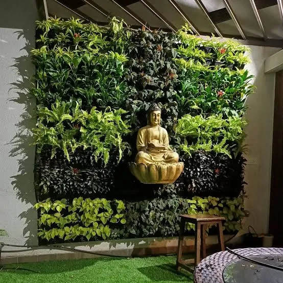 Indoor vertical garden green wall with Buddha statue for a living room