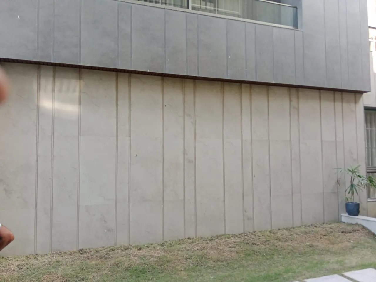 Lawn along a grey clad wall at a residential project