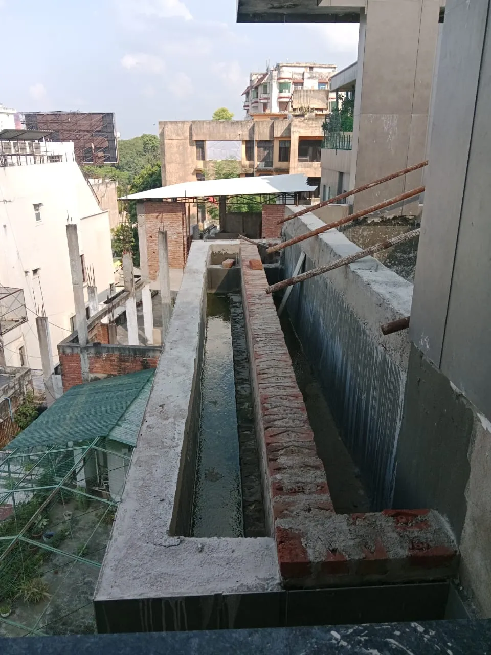 Long brick planter trough built along a high-rise balcony