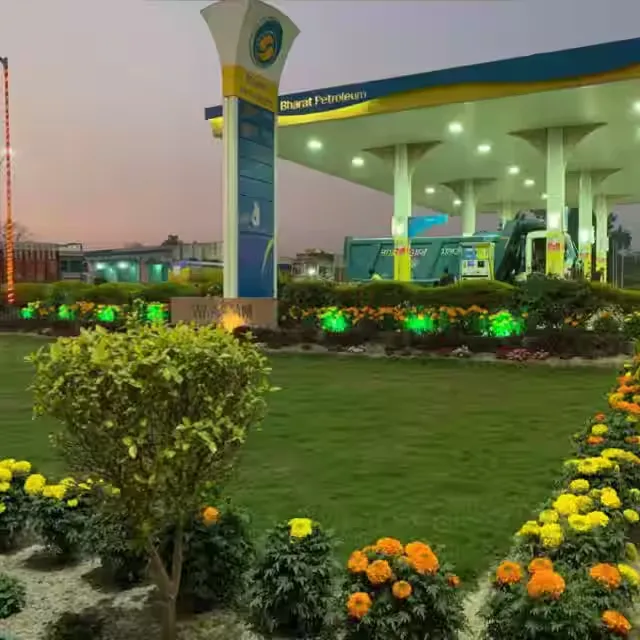 Petrol pump landscaping with lawn and marigold beds at a Bharat Petroleum outlet