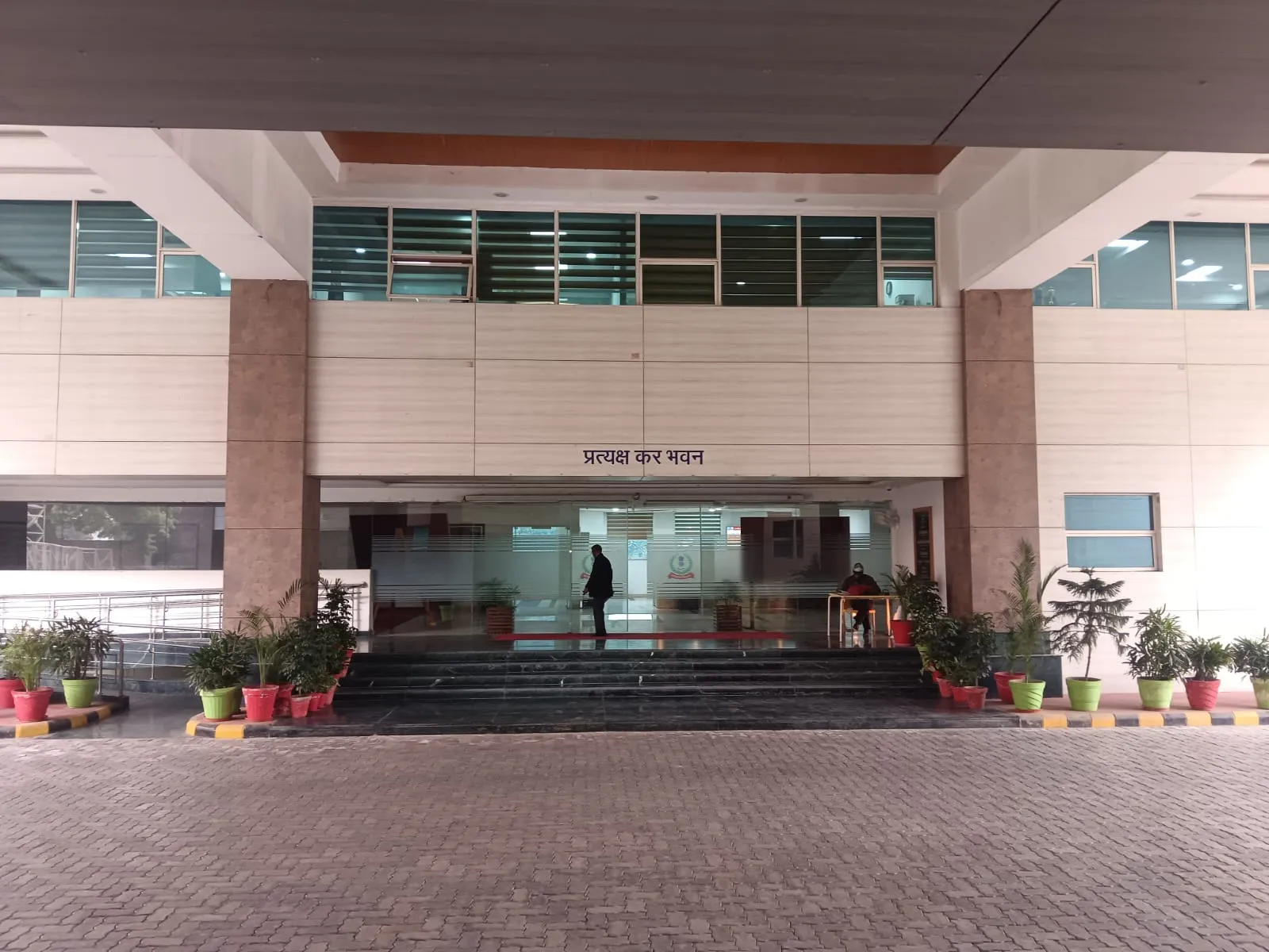 Pratyaksh Kar Bhawan entrance with potted plant arrangement in Lucknow