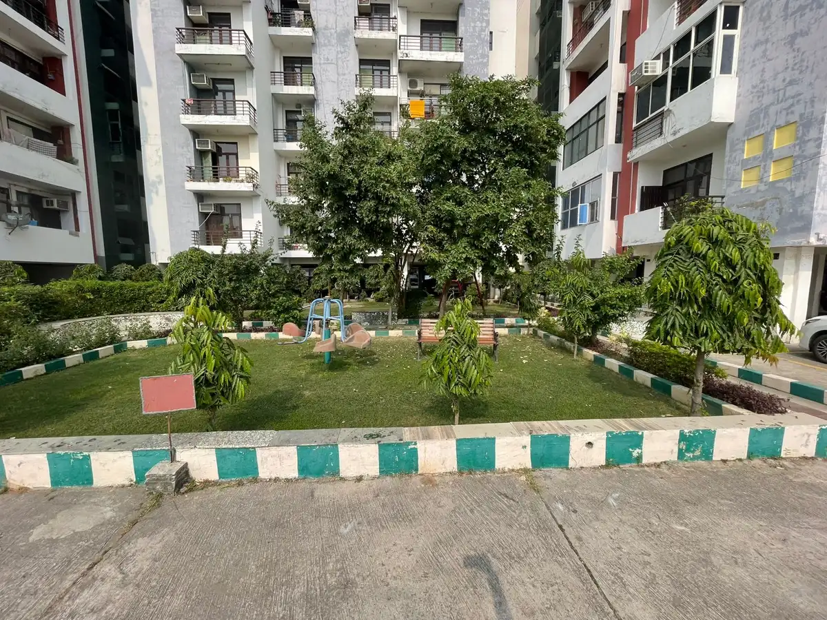 Small society garden with young trees before park redevelopment between apartment blocks