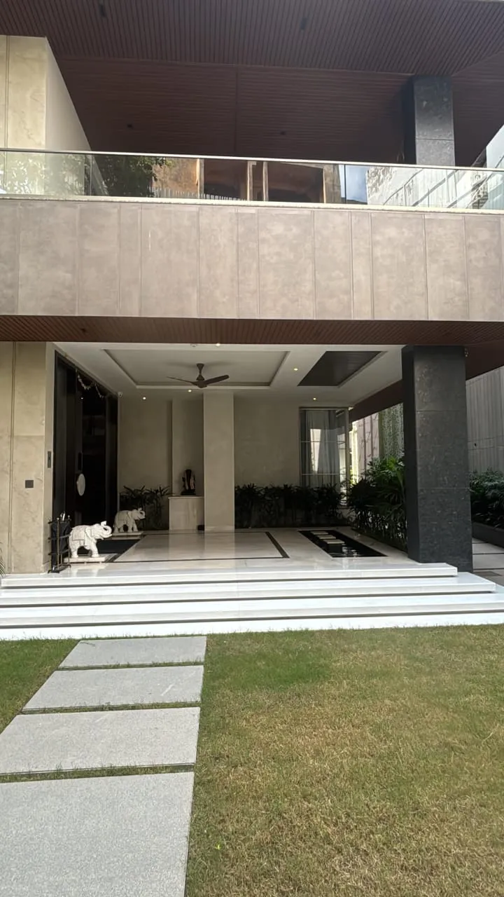 Stone stepping pavers across a lawn to a house entrance