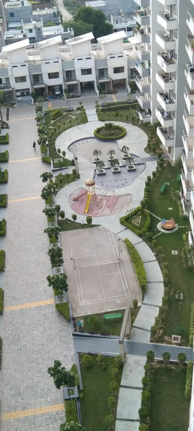 Residential society landscaping with central lawn, play area and landscaped walkways